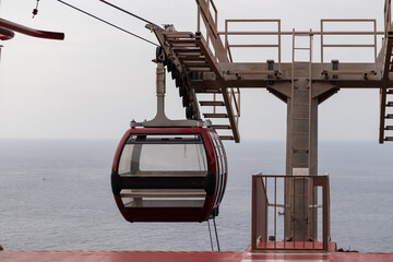 Empty cable car going to the beach of Garajau, Canico, Madeira island, Portugal, Europe. Panoramic view of majestic Atlantic Ocean with dramatic sky. Tourism. Travel destination. Tranquil scene