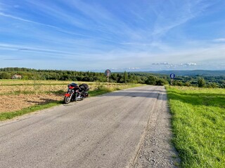 A motorcycle standing by the road.