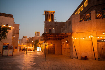 Fototapeta na wymiar Evening Ambiance in the Al Fahidi Historical Neighbourhood with Illuminated Wind Towers