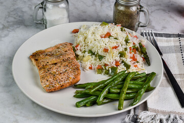 baked seasoned salmon  with rice and green beans;