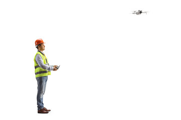 Engineer in a safety vest flying a drone with a remote controller