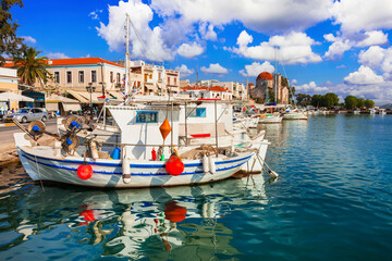 Saronics islands of Greece . Charming beautiful Greek island -Aegina with traditional fishing boats and St. Nicholas Church. - 746725371