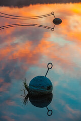 Serene Sunset Reflection on a Swedish Lake With Buoys