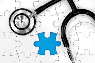 black stethoscope on white puzzle with missing piece and blue copy space, medical concept image represents a missing diagnosis
