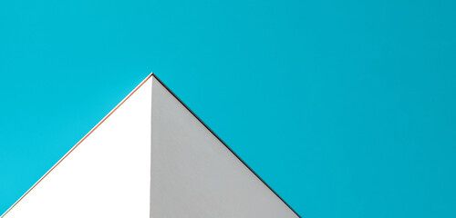Geometry in Architecture. Minimalism in Urban Photography. White Building Against Clear Blue Sky.