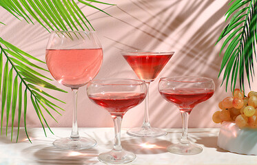 Festive alcoholic cocktails, glasses of wine and martini on a modern background with shadows, bar concept, alcoholic drinks at a party, banner for advertising a restaurant or cafe,