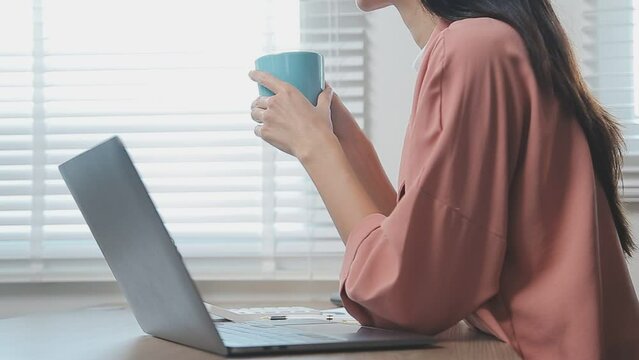 Charming woman with beautiful smile reading good news on mobile phone during rest in coffee shop, happy Caucasian female watching her photos on cell telephone while relaxing in cafe during free time