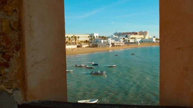 Revealing Playa la Caleta in Cadiz, Andalucia, Spain, picturesque beach nestled between historic fortresses, a favorite among tourists