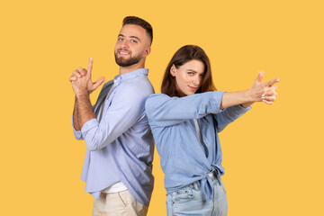 Fun couple back-to-back with finger guns