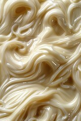 Swirls of creamy condiment texture, possibly mayonnaise or cream.