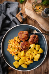 Meatballs  served with fired potatoes.