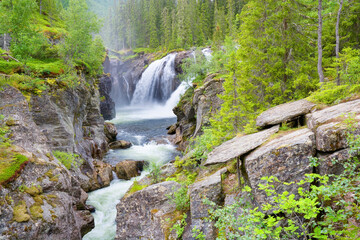 Fototapeta na wymiar Rjukandefossen waterfall in the vicinity of the village Tuv in the municipality of Hemsedal in Viken county, Norway