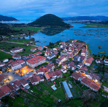 Dusk in the town of Escalante seen from a drone in the Parque Natural de las Marismas de Santo&ntilde;a, Victoria y Joyel Natural Park. Cantabrian Sea. Escalante, Cantabria, Spain, Europe