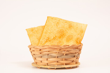 Fried Pastels Brazilian Pastel de Feira on a basket clean background isolated front top view