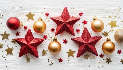 beautiful creative minimalistic christmas composition with golden red stars and balls on a white background flat lay top view