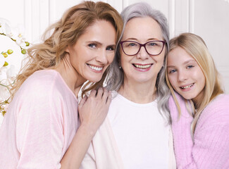 Portrait of three generations of women. Grandmother's birthday: a moment of joy and togetherness...