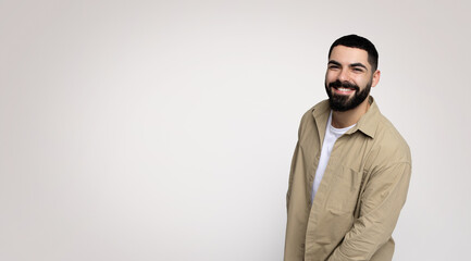 A jovial man with a beard and a wide smile leans slightly towards the camera