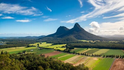 glass house mountains sunshine coast queensland australia showing blue sky mountains paddocks farming land and forests