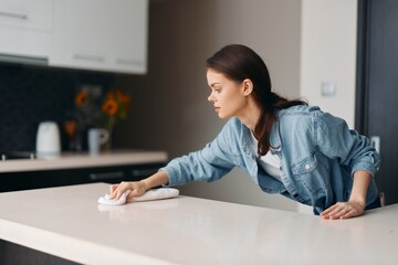 Happy Young Woman Cleaning House with a Smile: Hygiene, Cleanliness, and Happiness in a Domestic Setting.