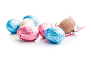 Easter chocolate eggs wrapped in aluminium foil isolated on white background.