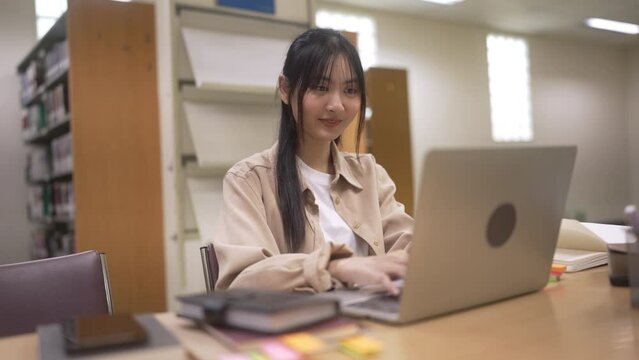 University student doing homework at library