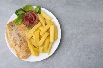 Foto op Plexiglas Delicious fish and chips with ketchup, spinach and lettuce on gray table, top view. Space for text © New Africa