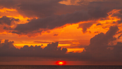 Coastal landscape with dramatic red sky over the ocean on a sunset
