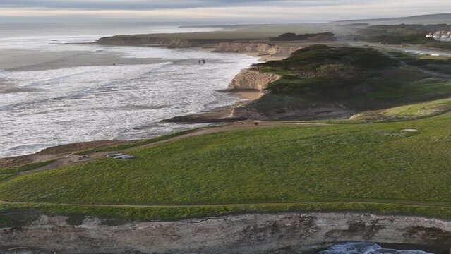 Aerial coverage of cliffs of Davenport Beach at sunset