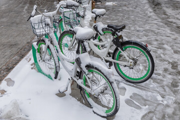Bicycle covered with snow in winter. Bike covered with fresh snow. Bicycle in the snow