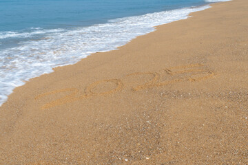 2025 written in the sand on the beach - Happy New Year