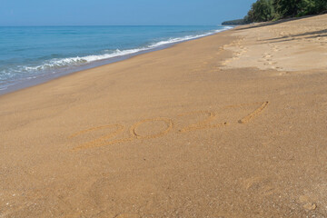2027 written in the sand on the beach - Happy New Year  