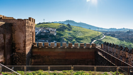View of the wall and mountains surrounding the monumental city of Caceres, Extremadura.