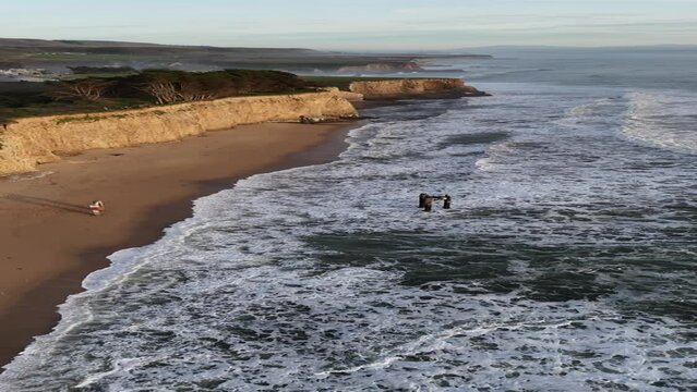 Aerial views of Davenport Beach and cliffs at sunset