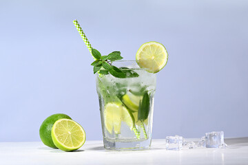 Glass with mojito cocktail and limes