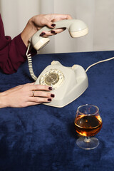 Vintage telephone and glass of cognac
