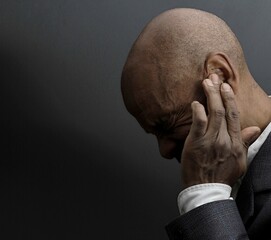 man suffering from deafness and hearing loss with people stock image stock photo	