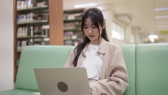 University student doing homework at library