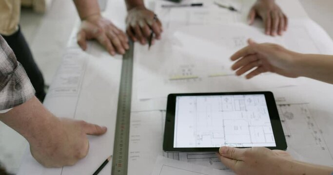 Blueprint, tablet screen and hands or teamwork in construction, building and planning with industry software. People for floor plan solution and digital technology, engineering or architecture design