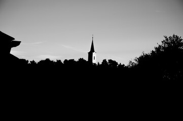 Obraz premium Black and white background with silhouettes of tower on sky.