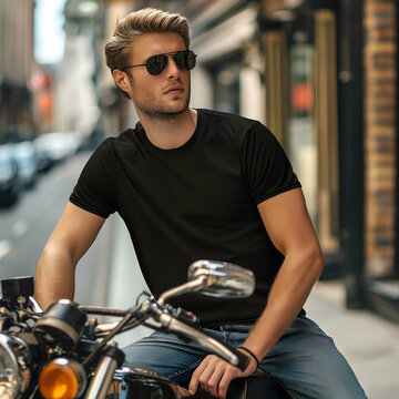 Handsom male biker model with motorcycle wearing blank black t-shirt mockup template for your tshirt design and copy