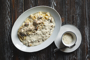 Italian pasta with parmesan and mushroom sauce, food photography.