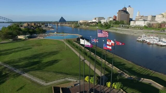 Waving Flags in Mud Island River Park, Memphis, Tennessee. Hernando de Soto Bridge and Mississippi River in Background. Drone