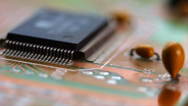 A detailed view of a motherboard, with the camera moving closely to highlight the circuitry and electronic parts.