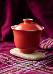 Red porcelain gaiwan on a stone - 746797969