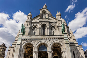 Fototapeta na wymiar Paris Basilica Sacre Coeur at top of Montmartre - Roman Catholic Church and minor basilica, dedicated to Sacred Heart of Jesus. Paris, France.