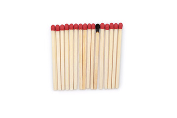 A row of red matches and one burnt match among them on a white background. Matches without a matchbox and a burnt match in the center of a close-up photo with space for text