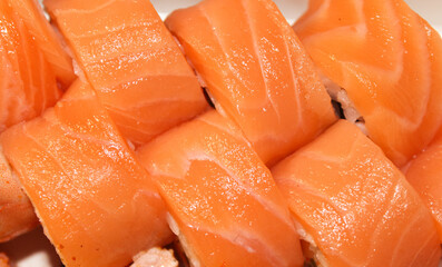 Beautiful close-up photo of sushi with salmon. Delicious Japanese food photo in high quality. Stock photo of sushi.