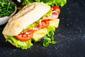 Ciabatta sandwich with lettuce, cheese, tomatoes and ham.