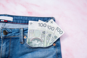 100 zloty banknotes in a jeans pocket