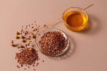 Brown linen seeds, flaxseed vegetable oil on beige background. Healthy super food